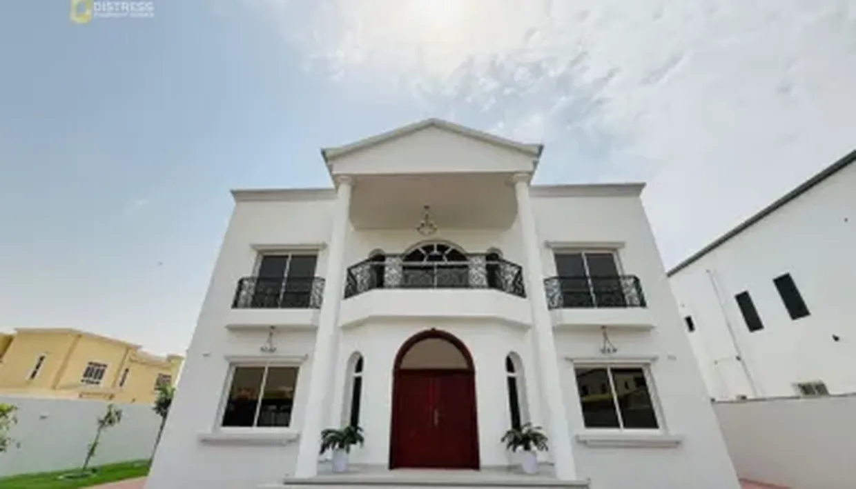 White two-storey villa with an arched entrance in Al Quoz, Dubai