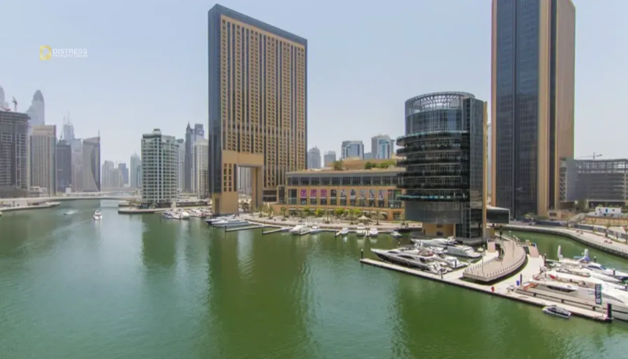 Dubai Marina canal with moored yachts and high-rise towers on both banks