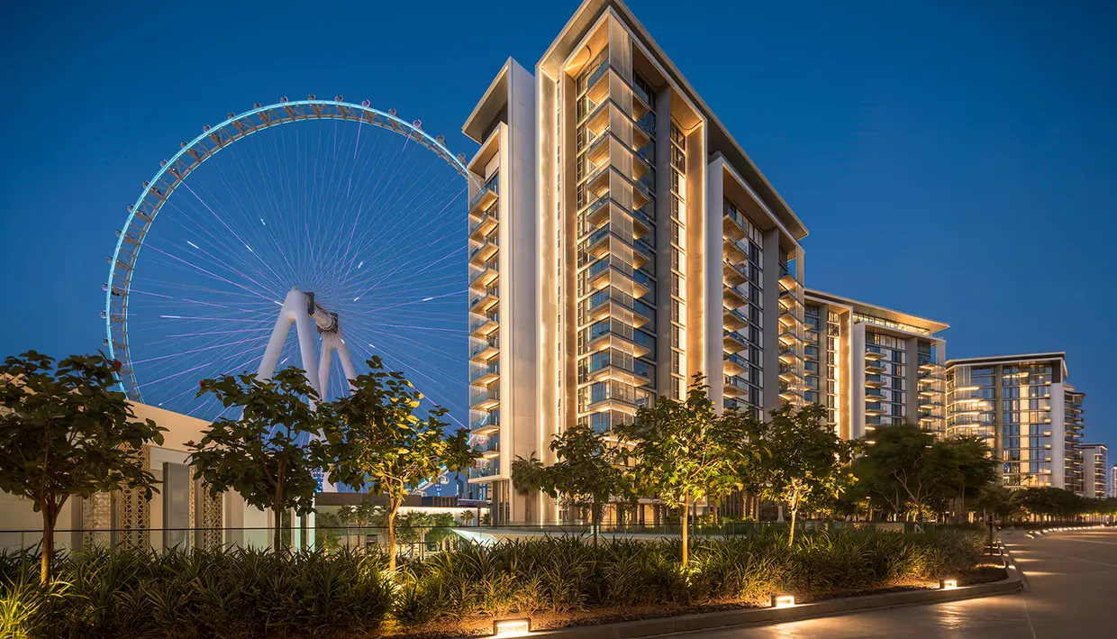 View of residential towers at dusk from Dubai Holding's real estate portfolio